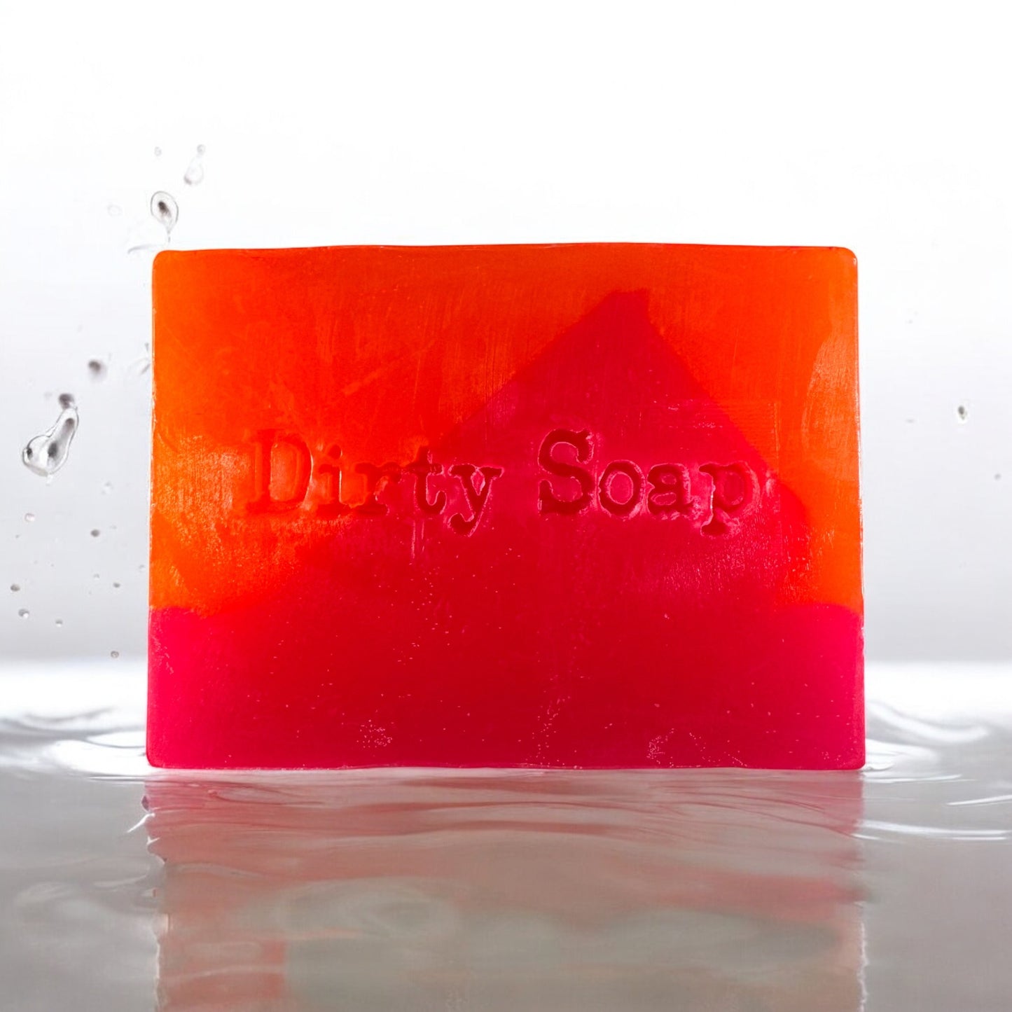 Miami slice pink and orange soap bar with dirty soap in text sat in a puddle of water