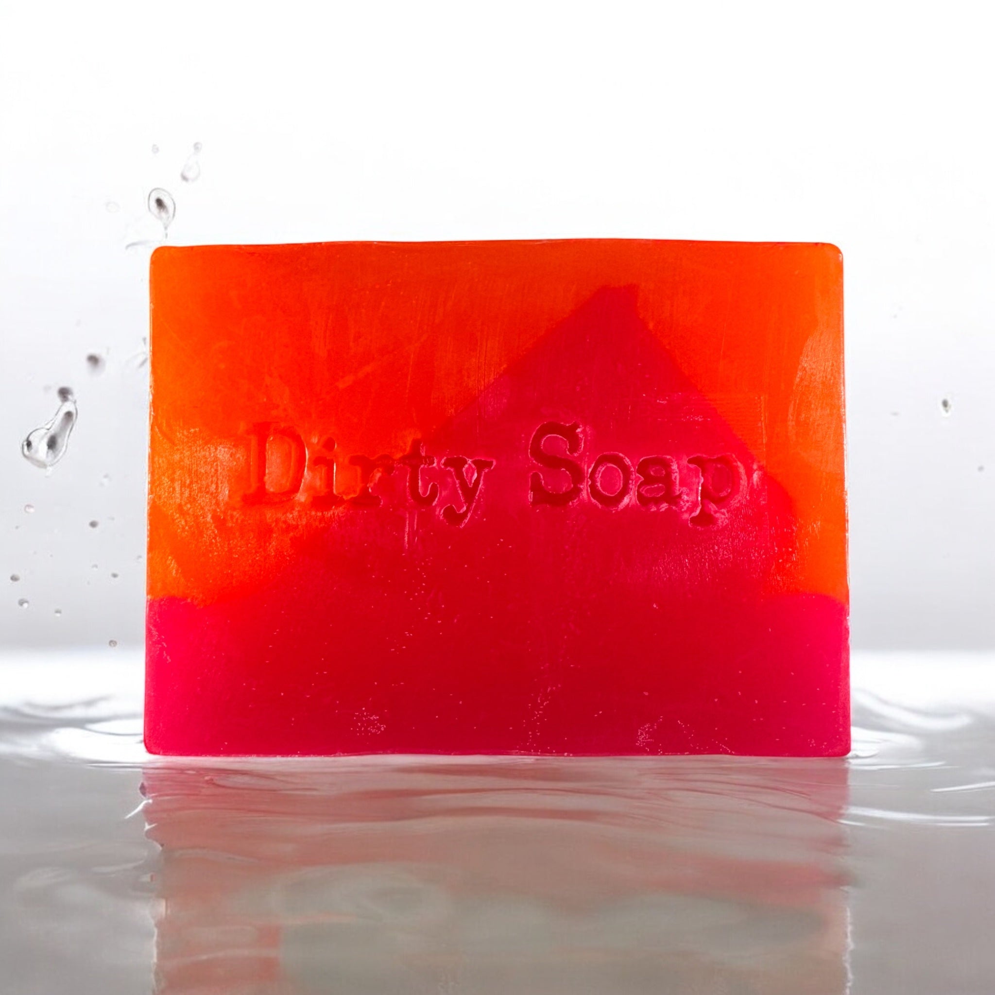 Miami slice pink and orange soap bar with dirty soap in text sat in a puddle of water